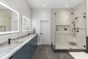 Luxury primary bathroom remodel with marble countertops, custom cabinets, LED Vanity lights, and free standing tub in Central Texas