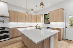 Luxury kitchen remodel with Quartzite backsplash and custom cabinets in Central Texas